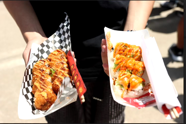 A student holding food from the food trucks