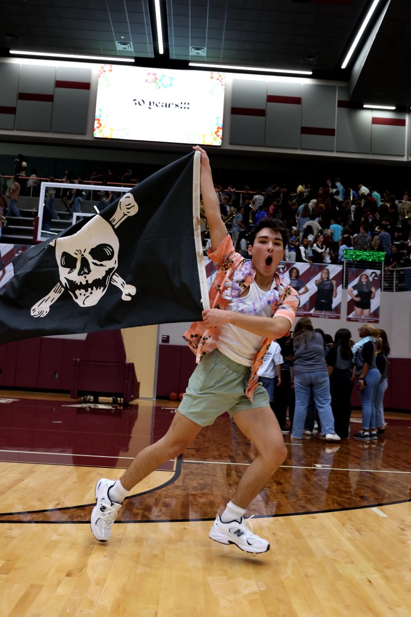 Capture the Flag: George Lannan waves the flag recently won by the seniors during the first pep rally used during the football games to keep students spirits up and support their football player.