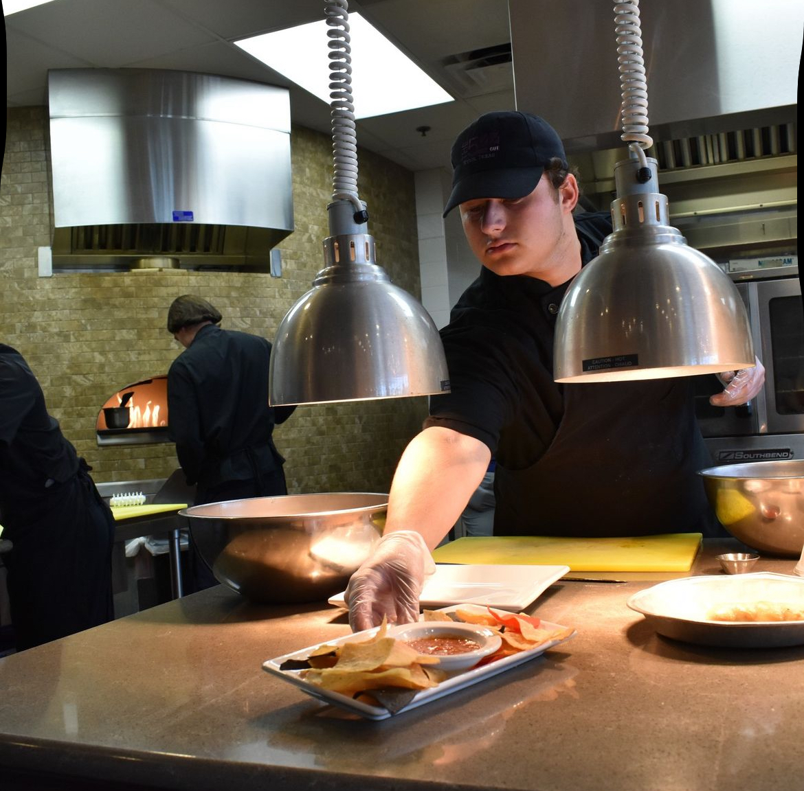 Decklin Roberts handing out prepared food to a waiter