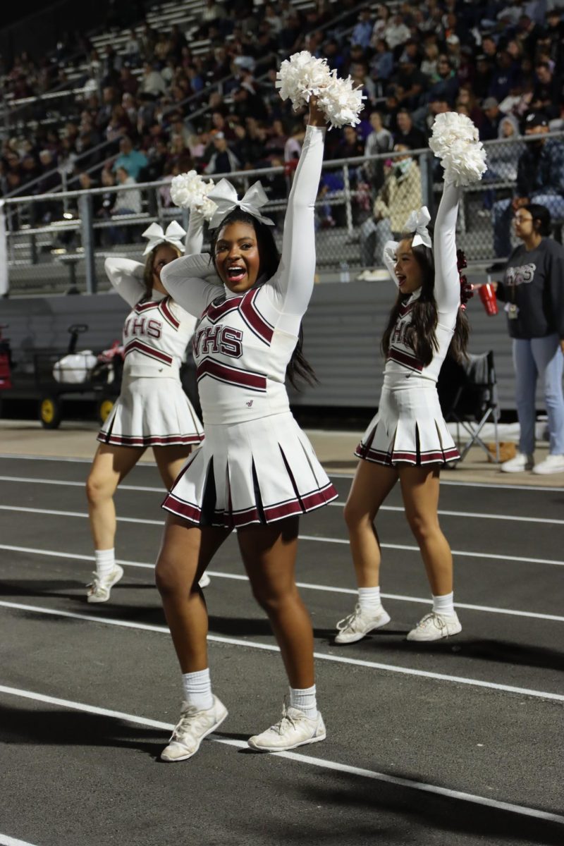 Fallon McMurrian cheering along side her teammates at the game against wylie East.