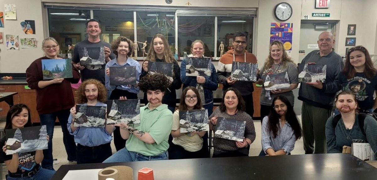 NAHS members and event participants taking a photo with their Bob Ross paintings.