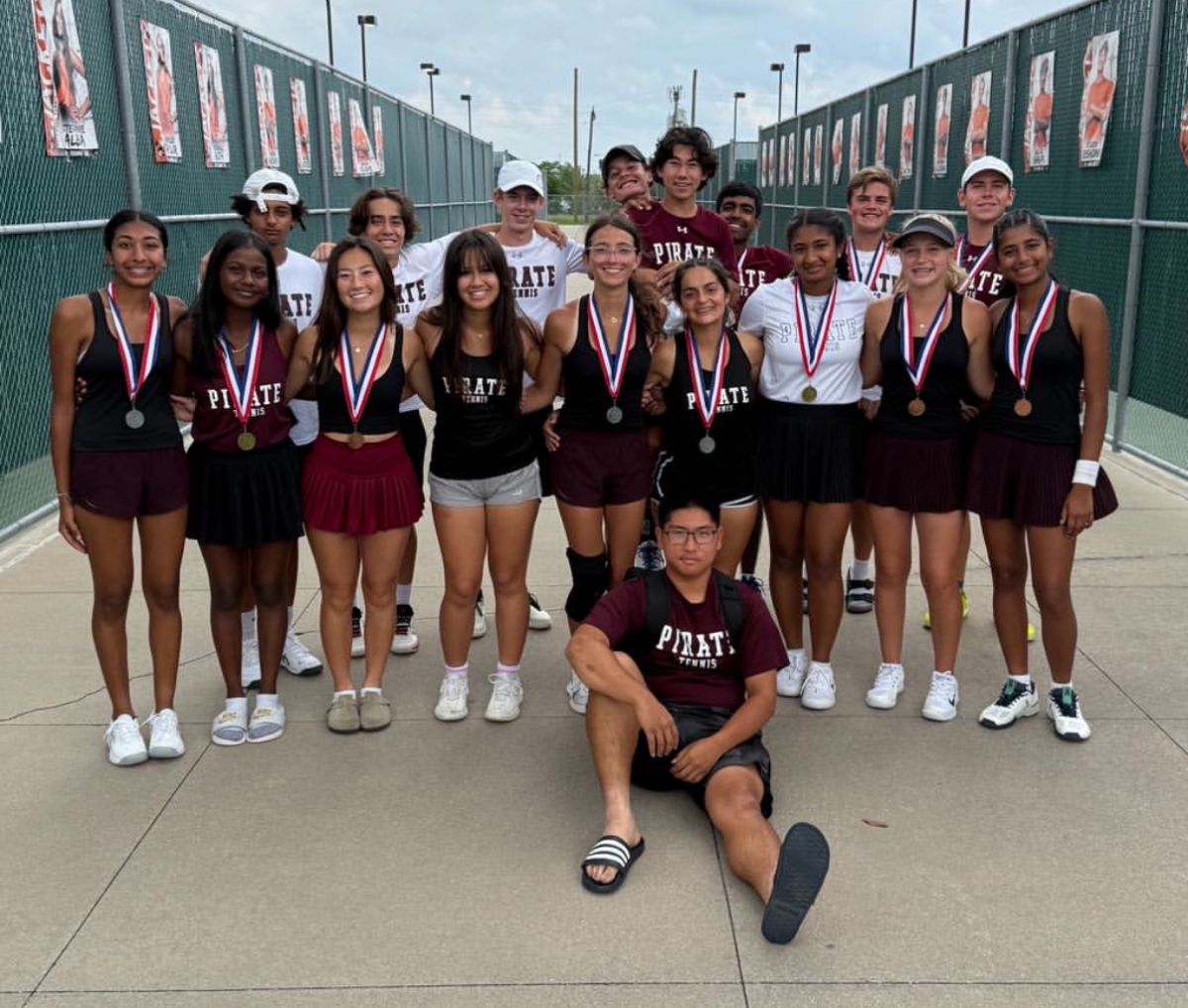 The tennis team poses with their medals after Districts.