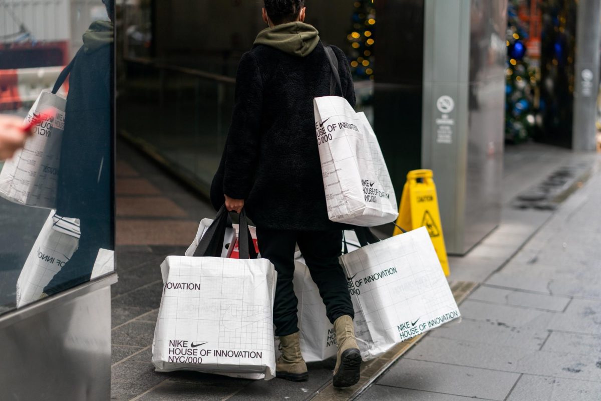 A shopper carries shopping bags on the 5th Avenue during Black Friday sales in the Manhattan borough of New York City, New York, U.S., November 26, 2021. REUTERS/Jeenah Moon