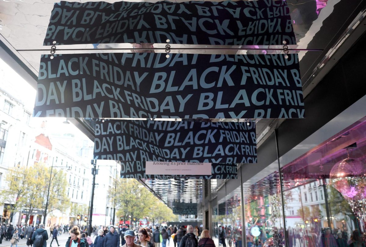Shoppers pass an advertisement for the Black Friday sales event on Regent Street in London, Britain, November 28, 2025. REUTERS/Toby Melville