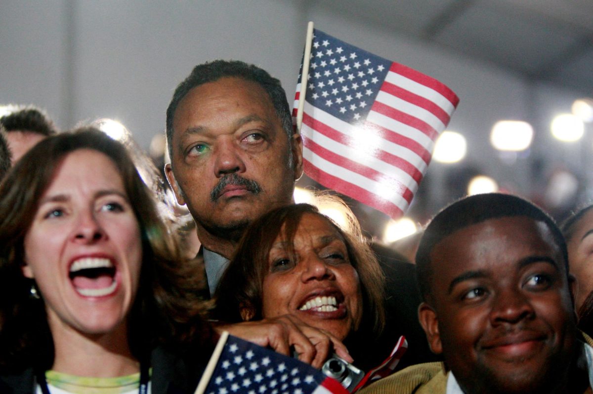 The Rev. Jesse Jackson (back), a former presidential candidate, watches U.S. Democratic President-elect Senator Barack Obama (D-IL) during Obama's election night rally in Chicago November 4, 2008.     REUTERS/Jason Reed