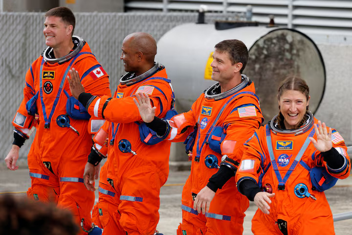 The crew of the Artemis II launch mission to fly by the moon, NASA astronauts Reid Wiseman, Victor Glover and Christina Koch and CSA (Canadian Space Agency) astronaut Jeremy Hansen greet people before boarding the astronaut van for their drive to launch pad 39B at the Kennedy Space Center in Cape Canaveral, Florida, U.S. April 1, 2026.